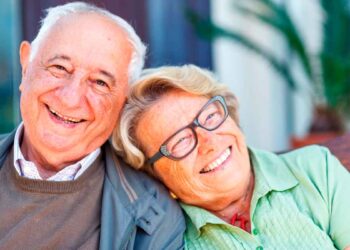 Pareja de jubilados sonrientes tras solicitar online el complemento de brecha de género que eleva su pensión más de 100 € al mes