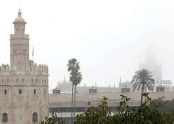 Torre del Oro y la Giralda de Sevilla bajo densa niebla durante el episodio de viento y lluvia del 6 de mayo de 2025 en Andalucía