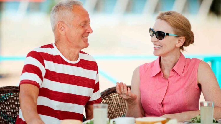 Pareja de jubilados europeos conversando relajadamente en una terraza, representando el ranking de pensiones más altas y bajas de Europa