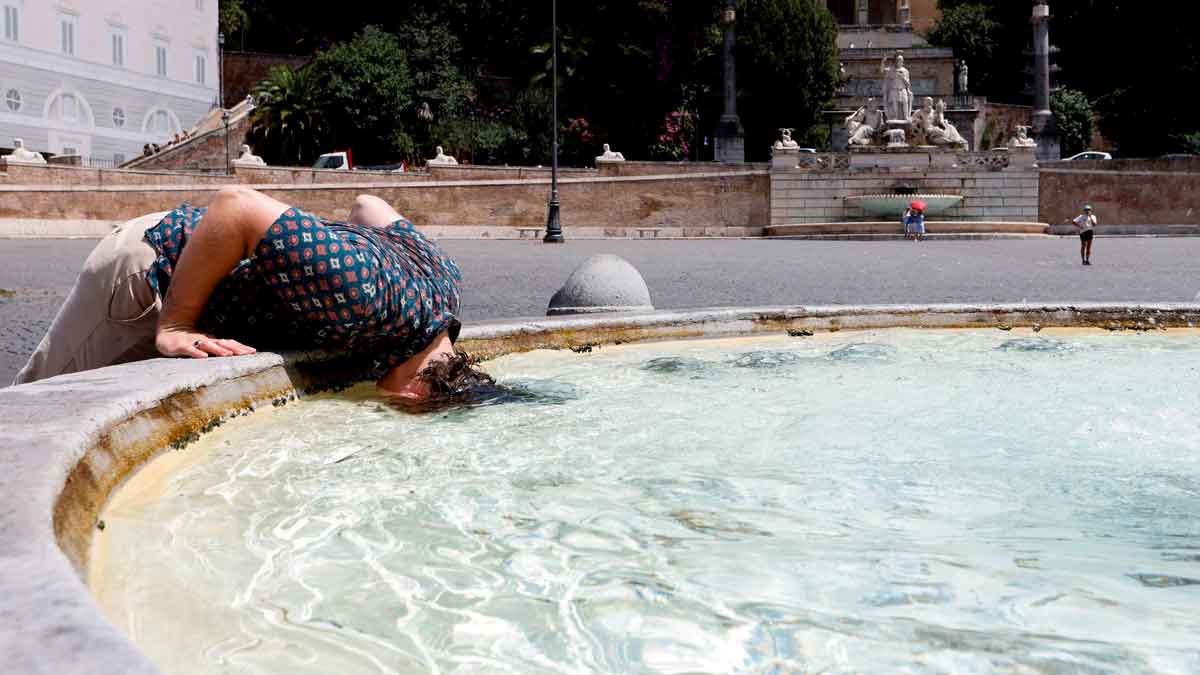 Persona refrescándose en una fuente durante la ola de calor extremo en Andalucía en agosto de 2025