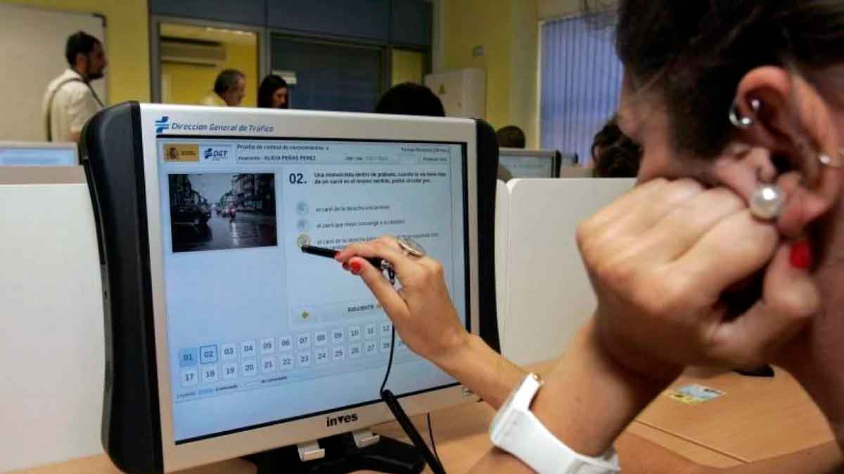 Alumno realizando examen teórico de conducir en la DGT en un aula informatizada
