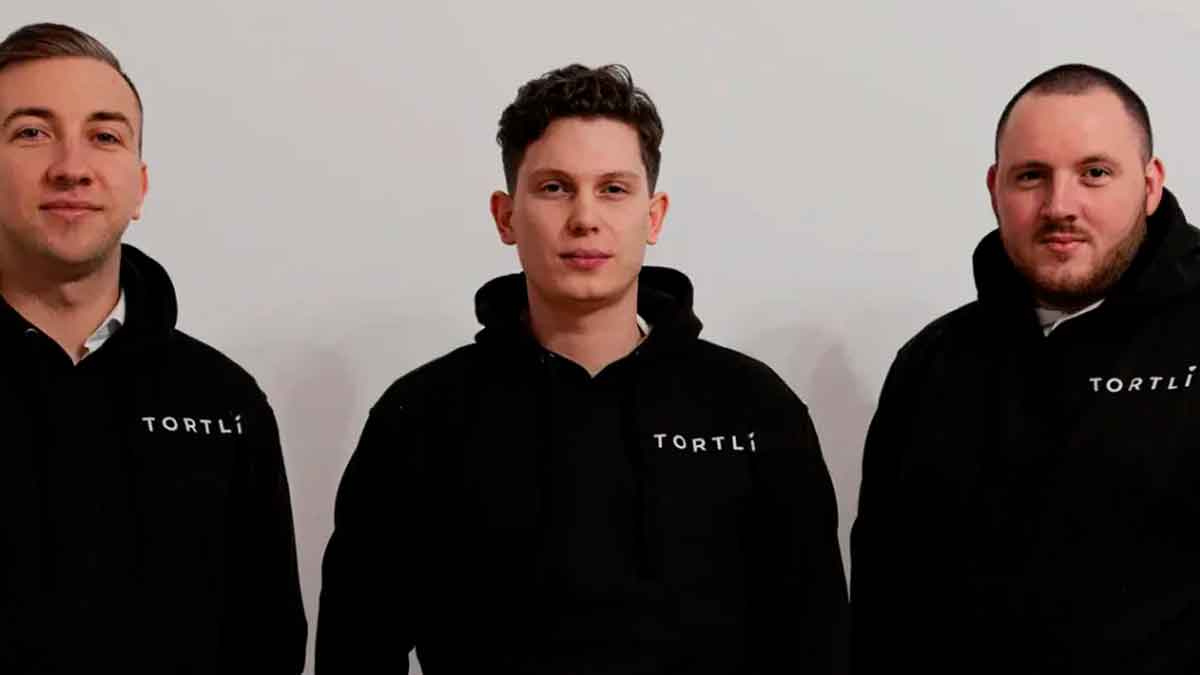 Tres jóvenes emprendedores fundadores de Tortli con sudaderas negras de su empresa