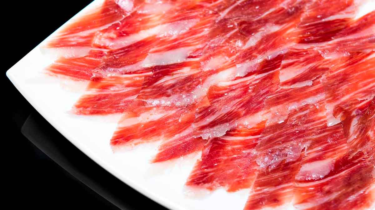 Lonchas de jamón ibérico de bellota del Valle de los Pedroches servidas en un plato blanco