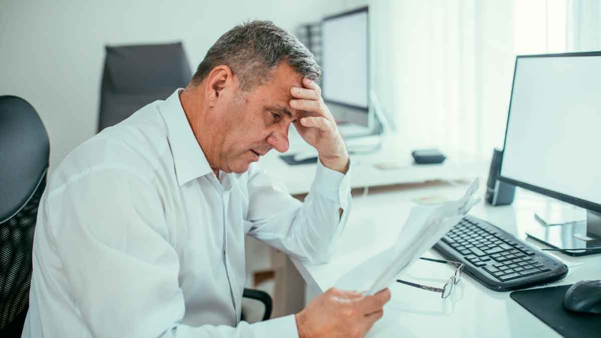 Autónomo revisando documentos con preocupación por su jubilación debido a cuotas pendientes y la aplicación del principio de contributividad